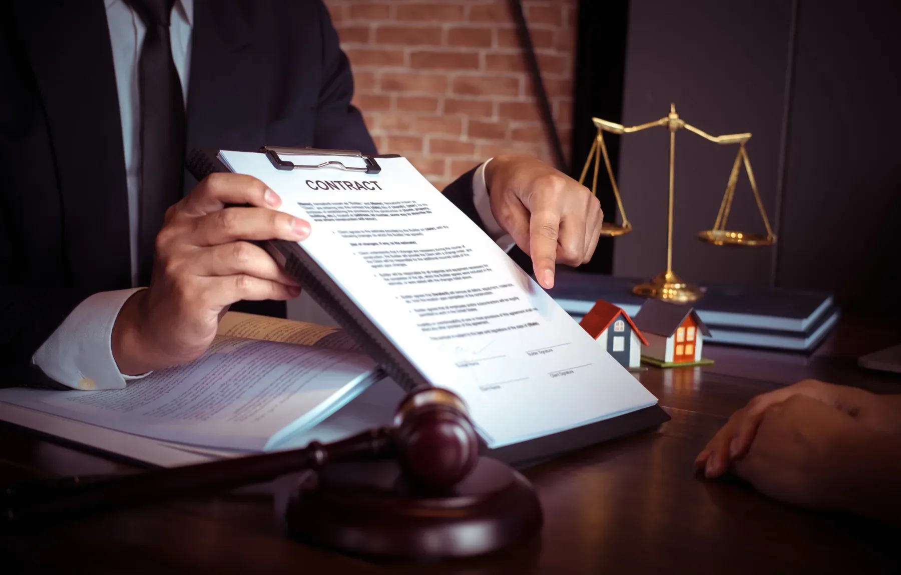 A lawyer presents a contract document to a client at an office desk, symbolizing legal agreement and professional legal servi